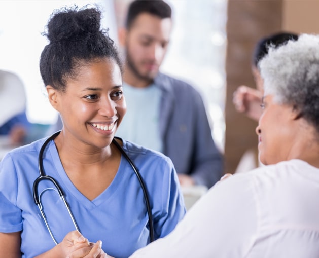 nurse smiling and talking to patient