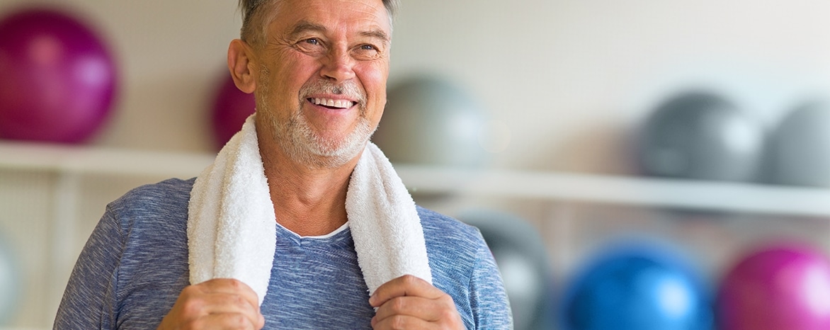 older man just finished workout with towel around his neck