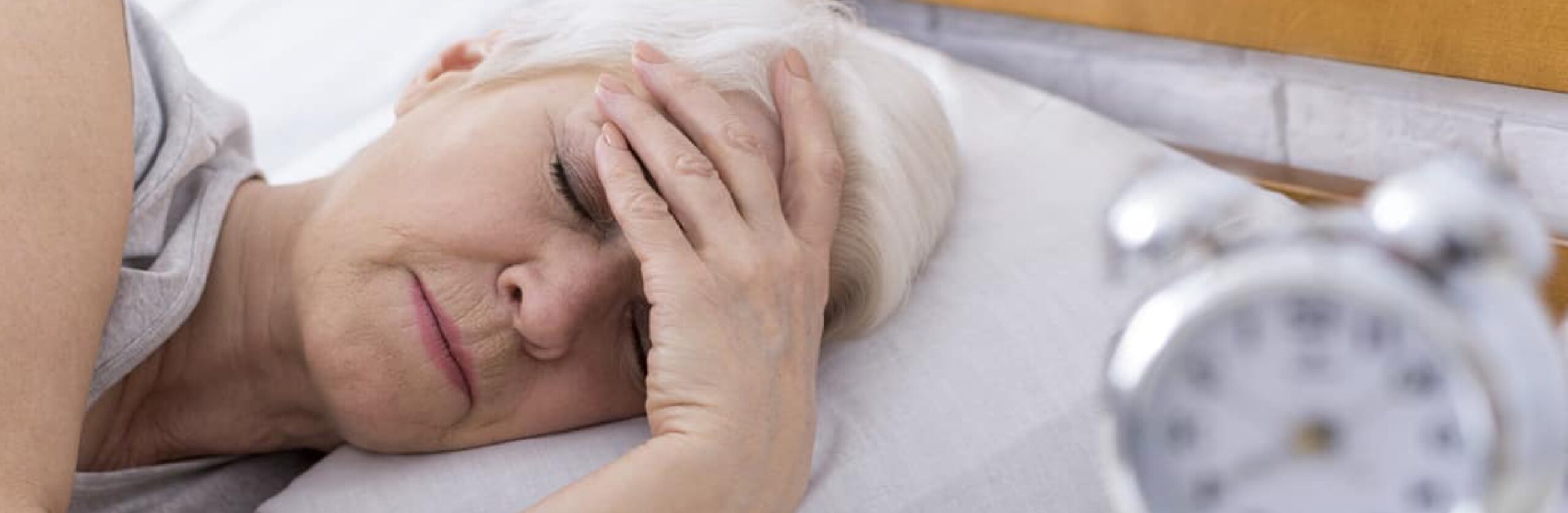 older woman having a hard time sleeping with central sleep apnea