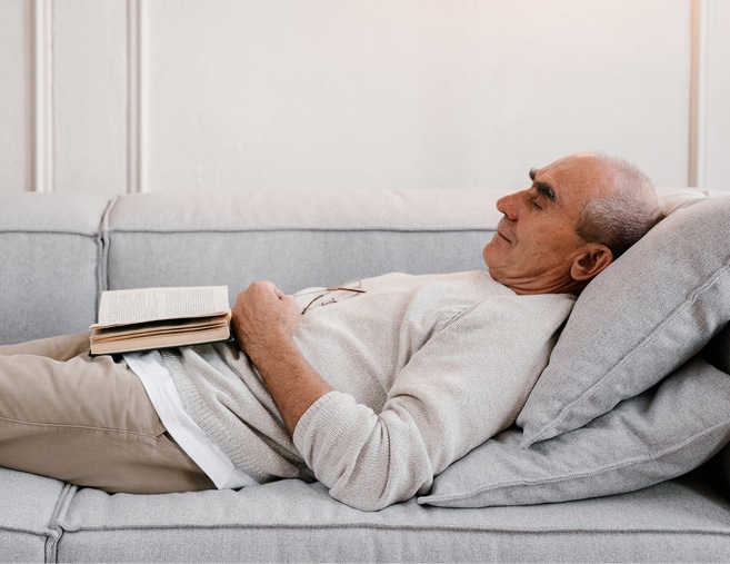 older man sleeping on couch